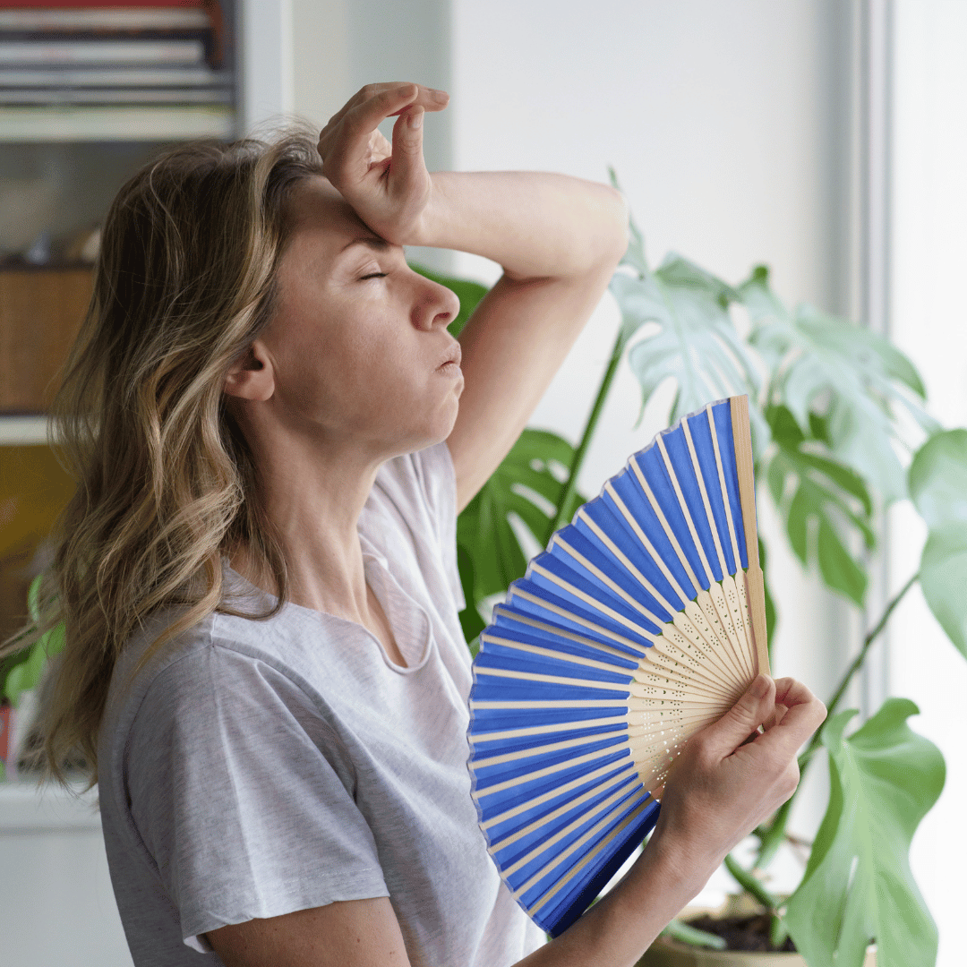 image of someone being hot at home during hot weather